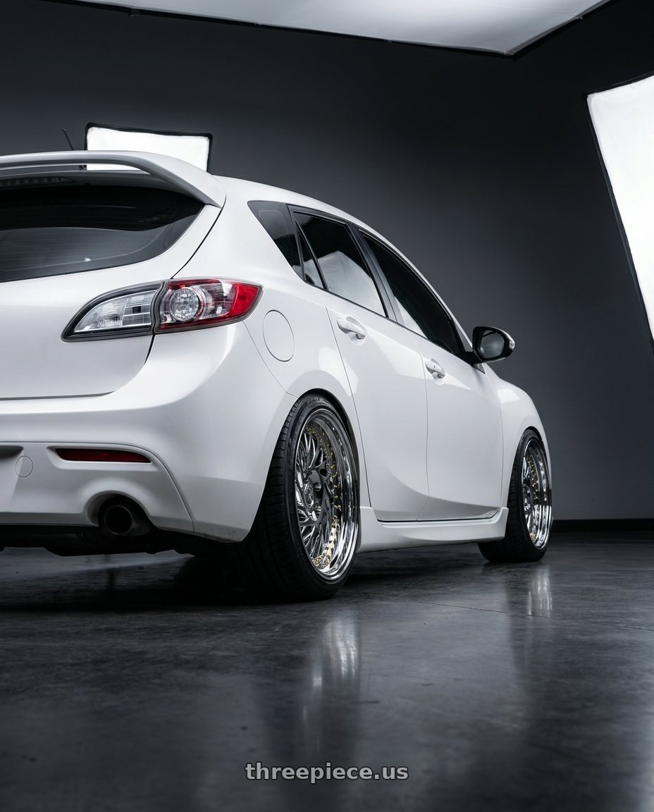 2012 Mazda Mazdaspeed3 with Aodhan DS03 5x114.3 18x9.5 +30 Vacuum Chrome w/Gold Rivets wheels rear three quarter view square tires