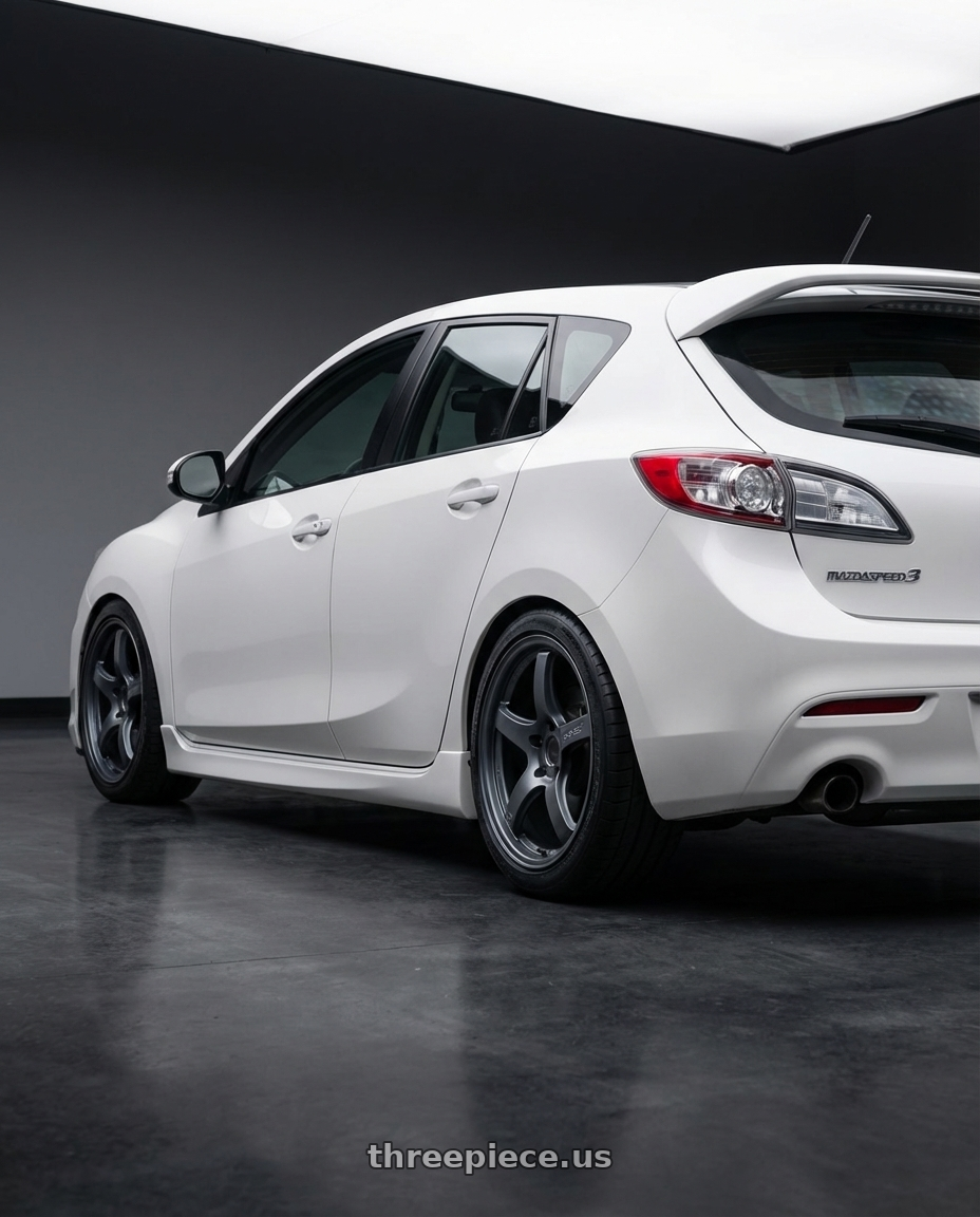 2012 Mazda Mazdaspeed3 with Gram Lights 57CR 5x114.3 18x9.5+22 Gunblue II wheels rear three quarter view square tires