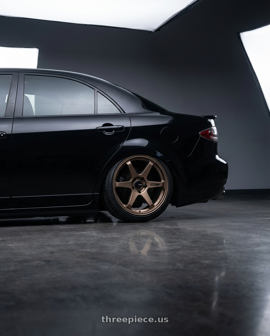 2006 Mazda, Mazdaspeed 6, Grand Touring, Black with Enkei T6R 5x114.3 18x8.5+38 Matte Bronze wheels rear three quarter view slight stretch tires