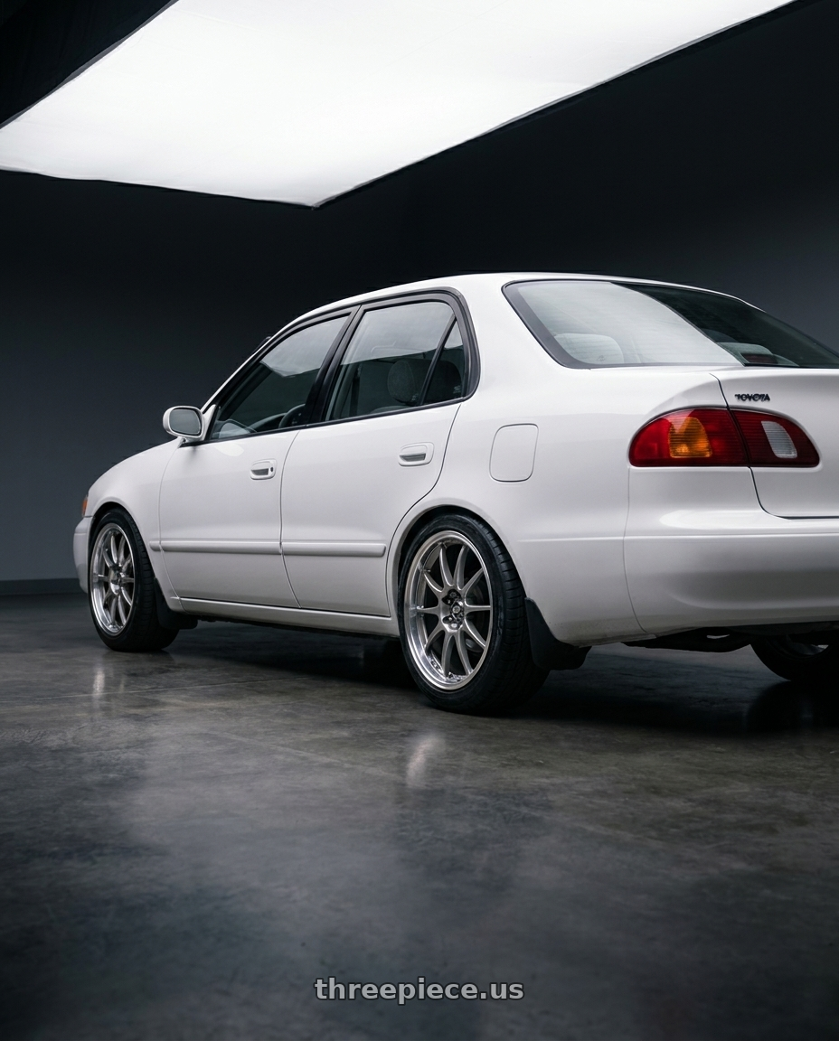 2001 toyota corolla ce with Enkei J10 4x100/114.3 17x7+42 Silver w/ Machined Lip wheels rear three quarter view slight stretch tires