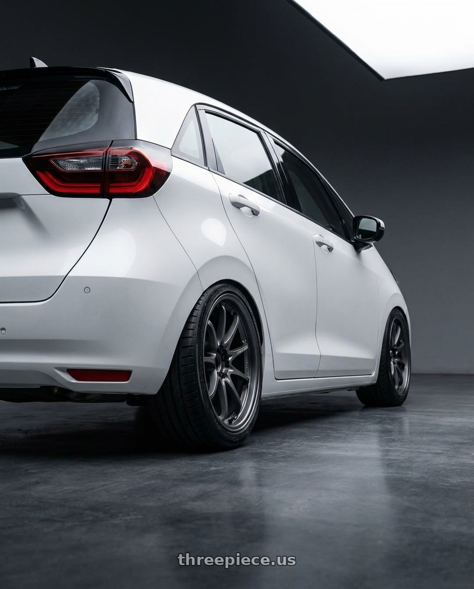 2025 honda fit4白色 with Volk Racing CE28N-PLUS M-SPEC 5x114.3 17x10 +38 BLAST GUNMETAL wheels rear three quarter view slight stretch tires