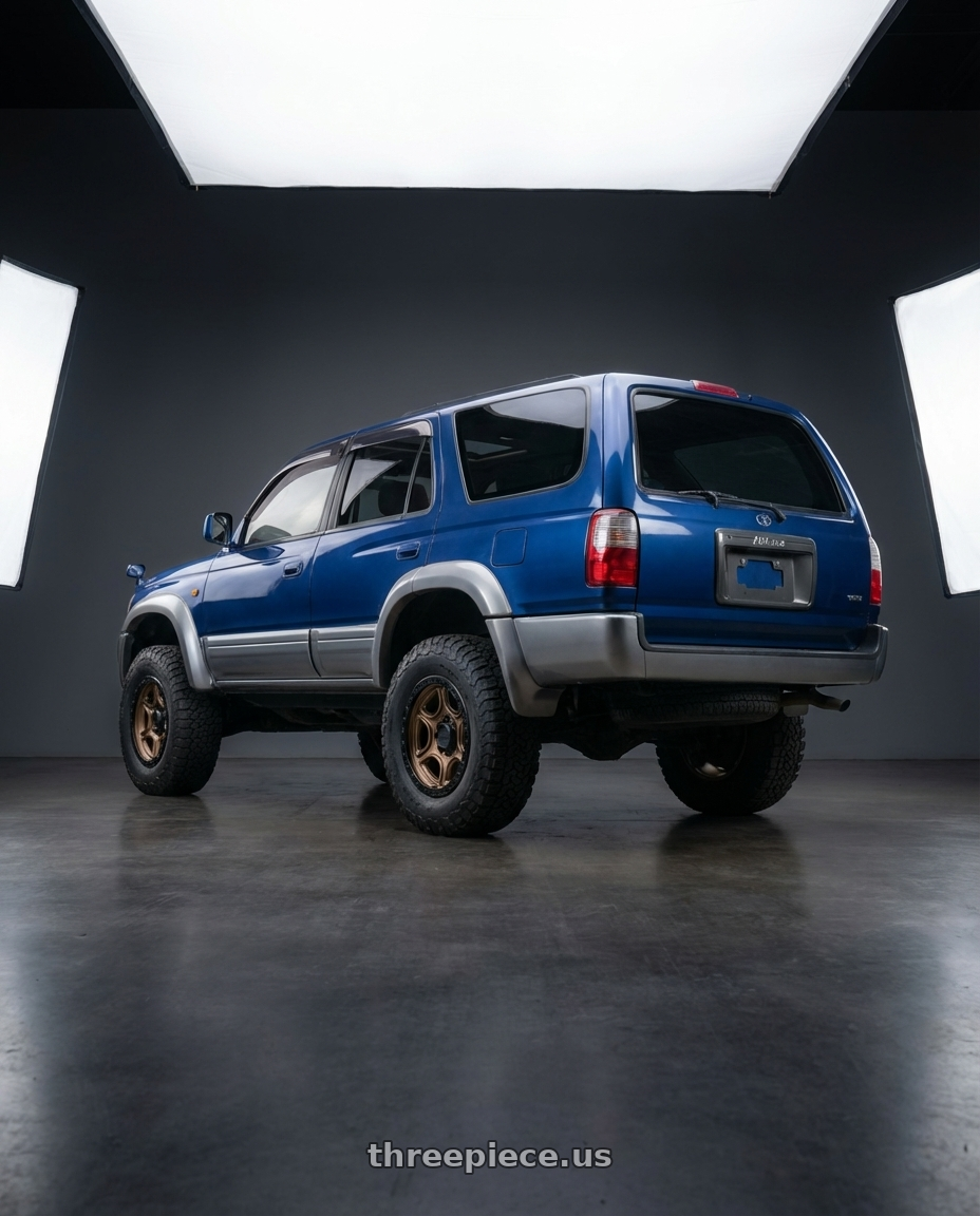 1996 Toyota Hilux surf with KMC KM539 PORTAL 5X127 17X8.5 +18 SATIN BRONZE SATIN BLACK LIP wheels rear three quarter view meaty tires