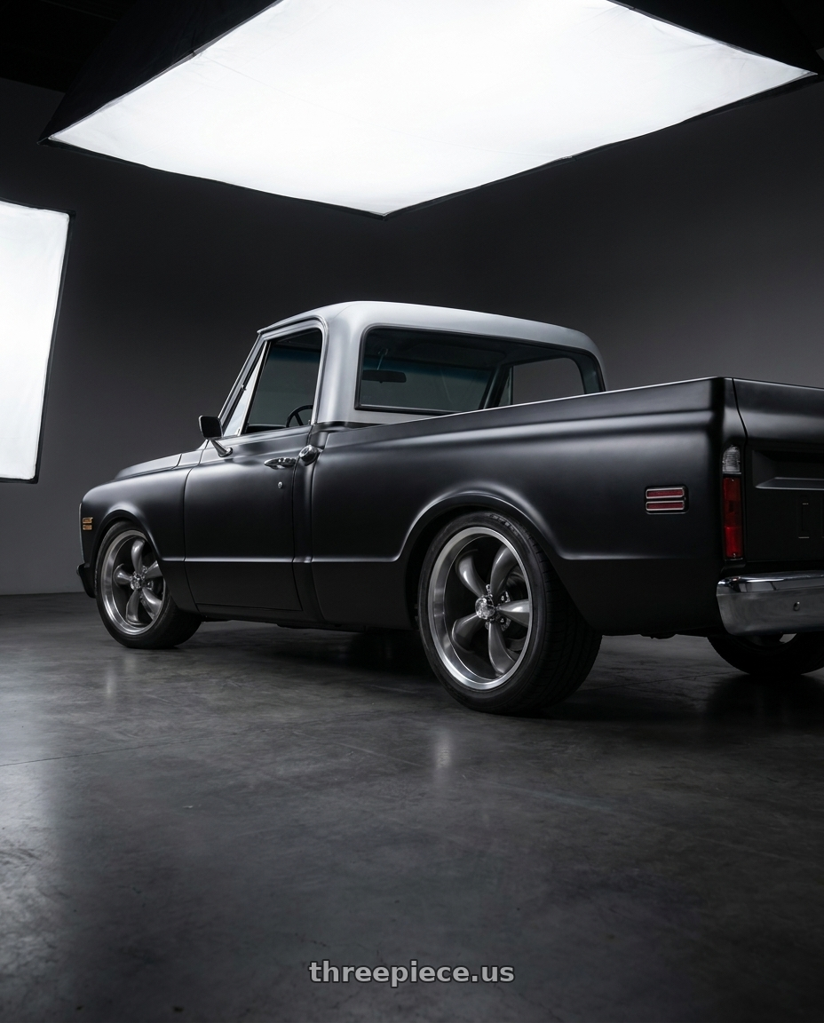 1969 Chevy c10 2 wd with Vision American-Muscle 142 Legend 6x139.7 20x9+20 Gunmetal Machined Lip wheels rear three quarter view slight stretch tires