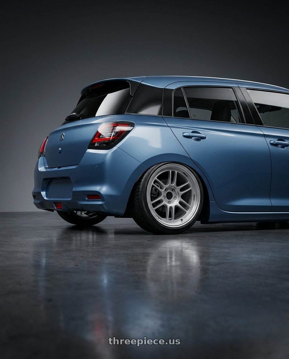 2026 Suzuki swift with Enkei RPF1 4x100 16x7+35 Silver wheels rear three quarter view slight stretch tires