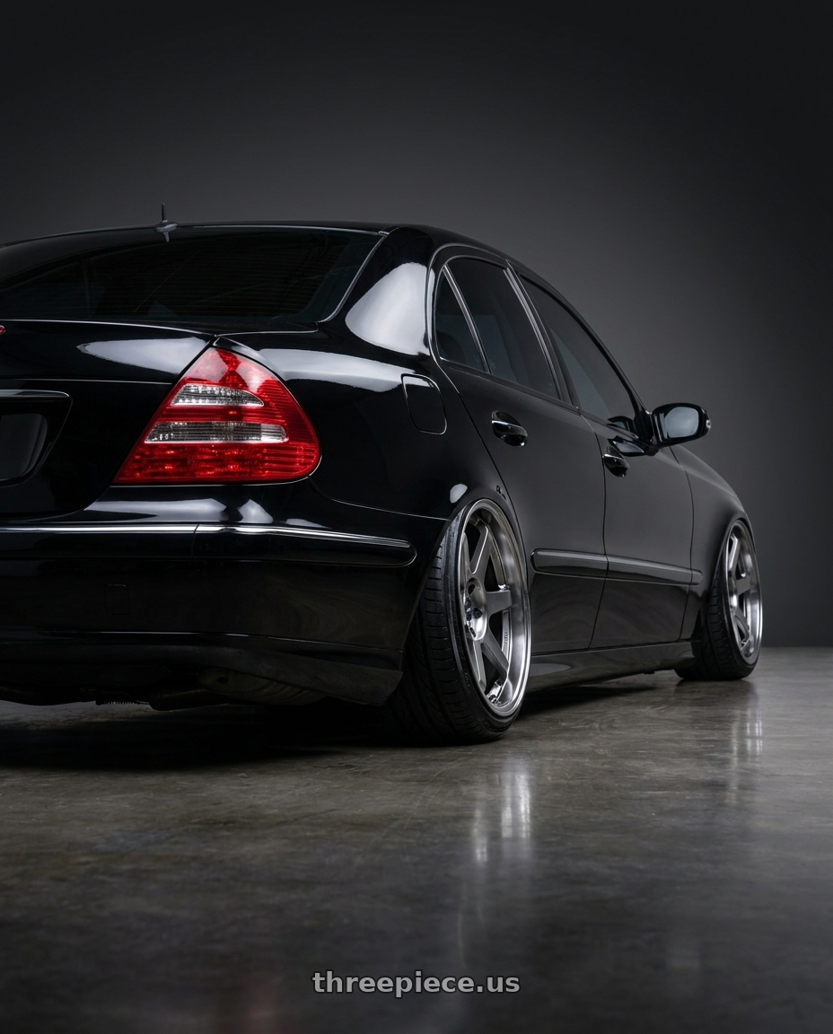 2005 Mercedes Benz E500 with Vors TR37 5x112 17x9 +30 Hyper Black wheels rear three quarter view extreme stretch tires