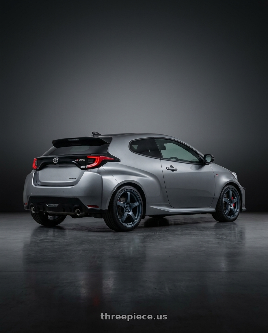 2024 GR YARIS 57CR grey with Gram Lights 57CR 5x114.3 18x8.5+50 Gunblue II wheels rear three quarter view square tires