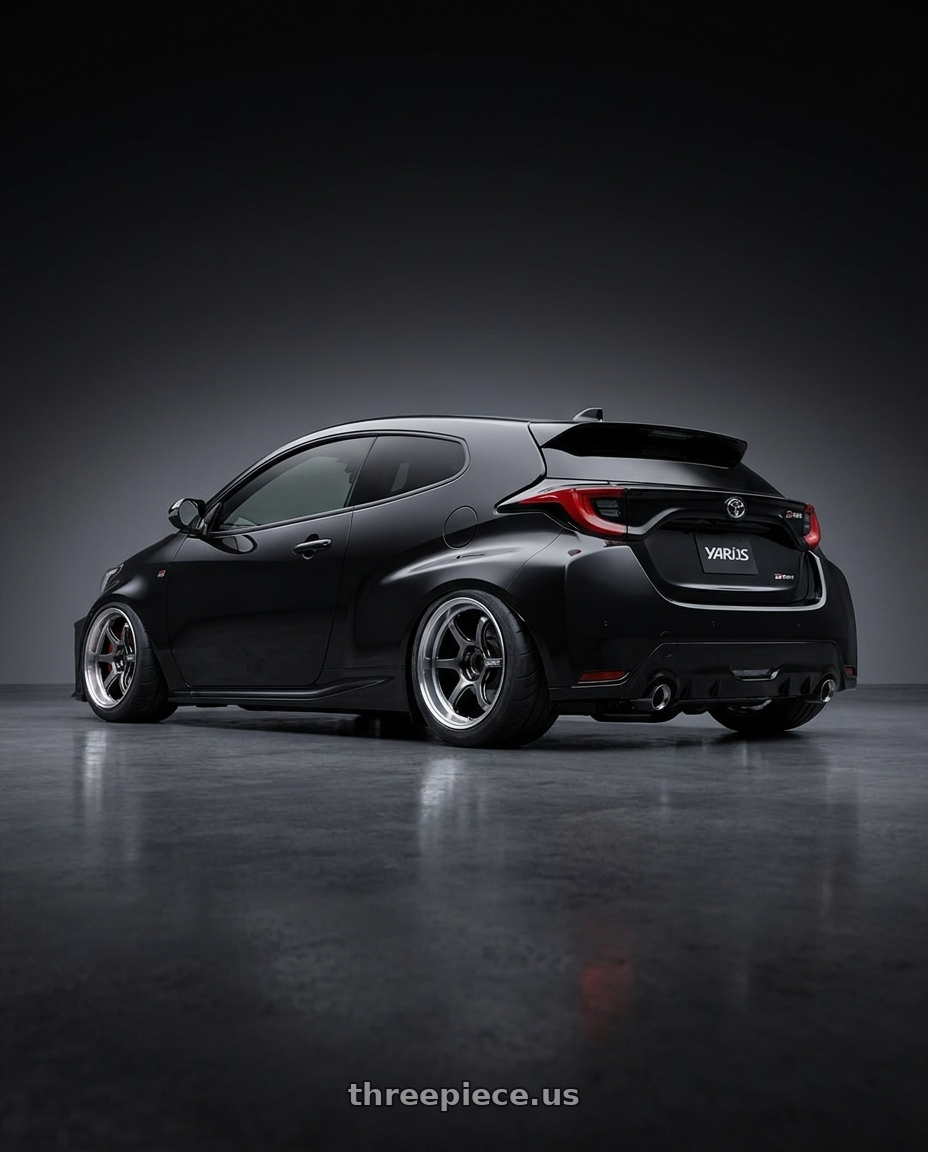 2024 Yaris GRMN black with Advan Racing R6 5x114.3 18x9.5 +29 MACHINING & HYPER PLATINUM BLACK wheels rear three quarter view meaty tires