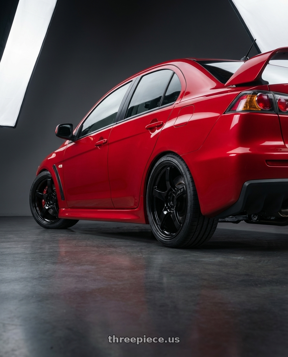 2012 Mitsubishi Lancer Evo X with Gram Lights 57CR 5x114.3 18x9.5+12 Glossy Black wheels rear three quarter view square tires