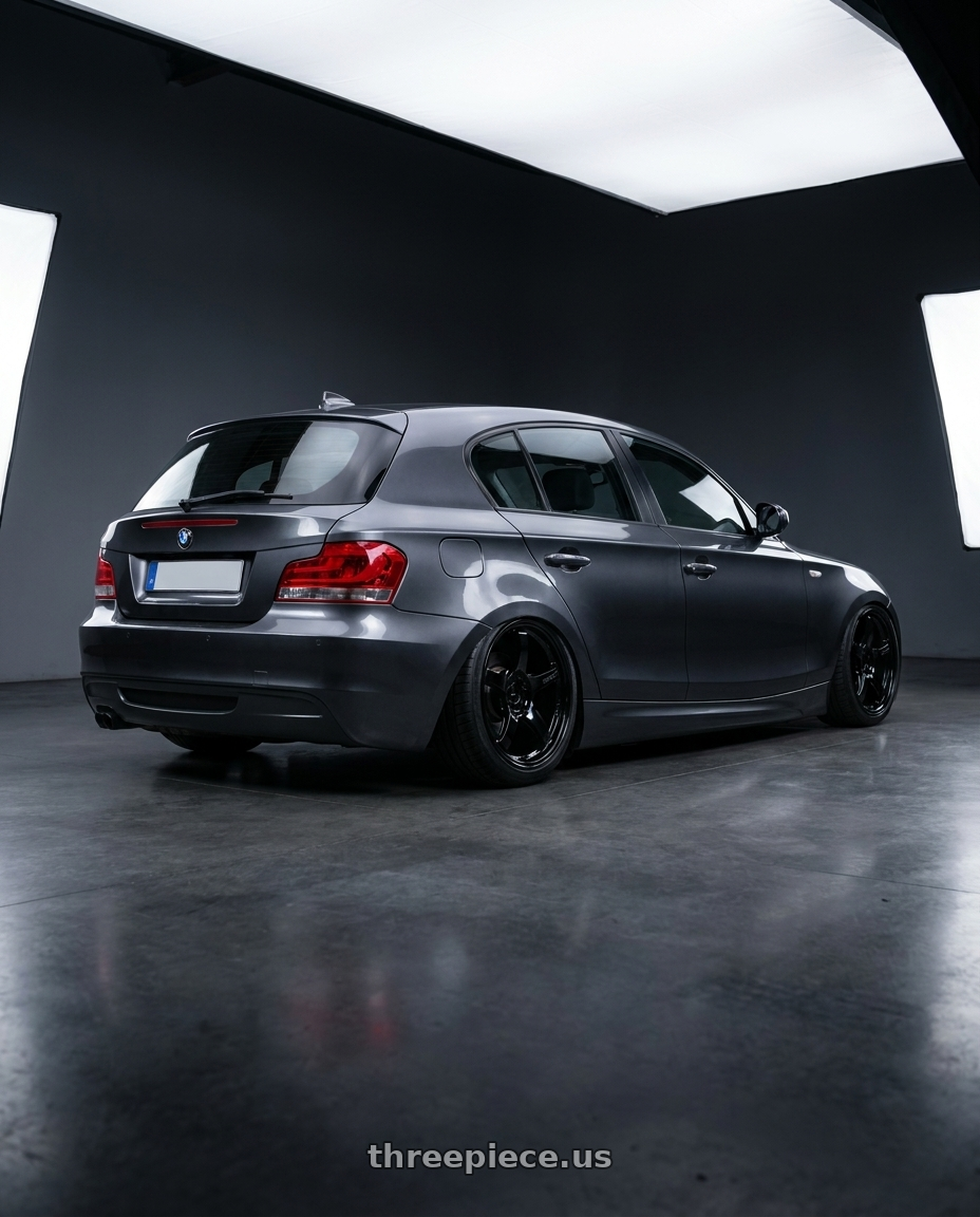 2012 BMW 1 Series E82 with Gram Lights 57CR 5x120 18x9.5+38 Glossy Black wheels rear three quarter view slight stretch tires