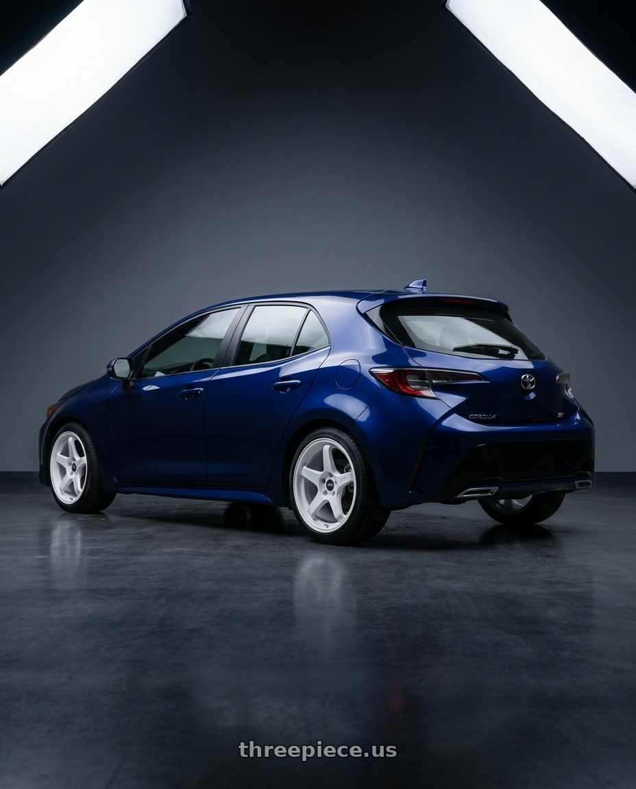 2024 toyota corolla hatchback se dark blue with ESR Wheels APEX SERIES APX5 5x100 18x8.5 +35 Gloss White wheels rear three quarter view square tires
