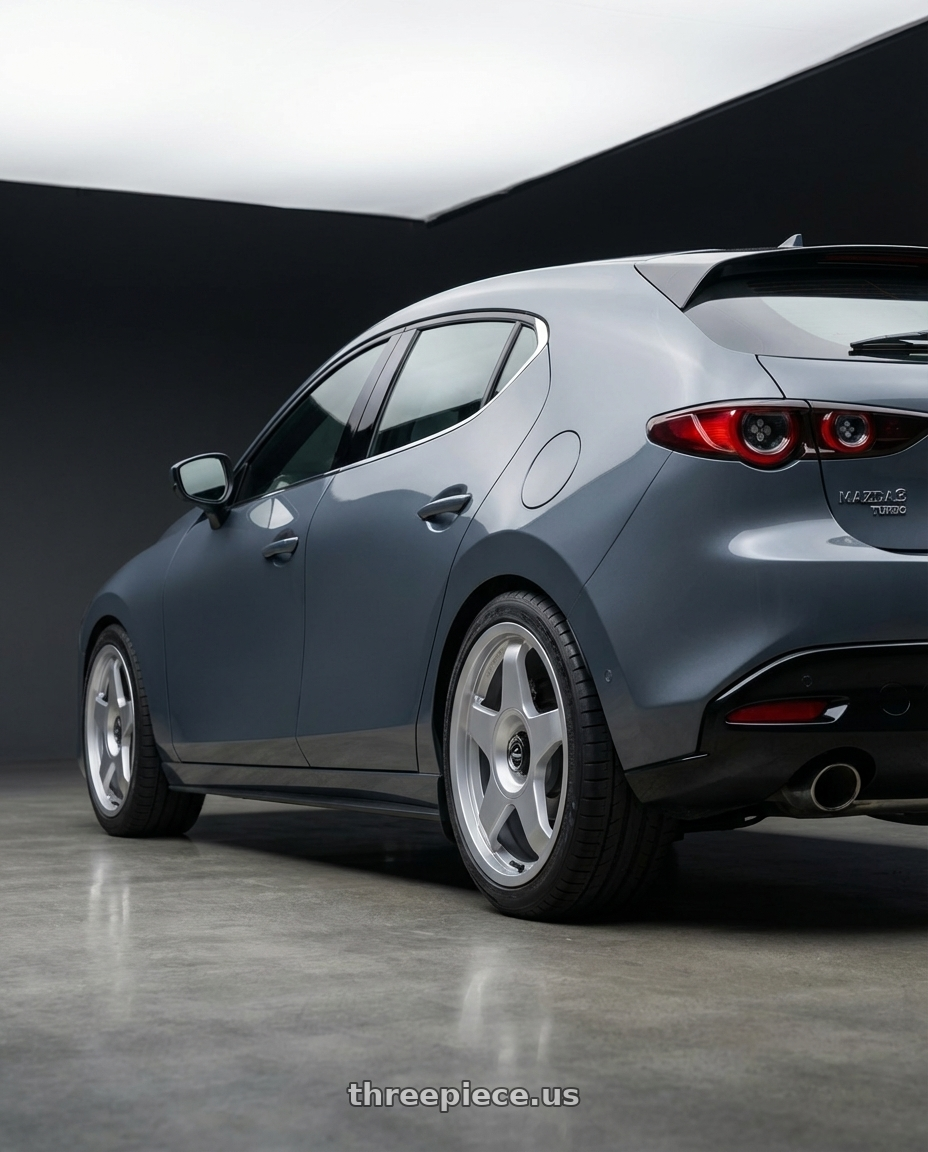 2023 Mazda Mazda3 Turbo with fifteen52 CHICANE 5x114.3 / 5x100 18x8.5 +35 SPEED SILVER (GLOSS SILVER) wheels rear three quarter view square tires