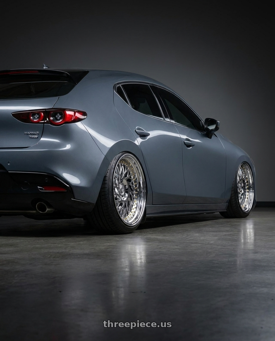 2023 Mazda Mazda3 Turbo with Aodhan DS03 5x114.3 18x9.5 +30 Vacuum Chrome w/Gold Rivets wheels rear three quarter view slight stretch tires