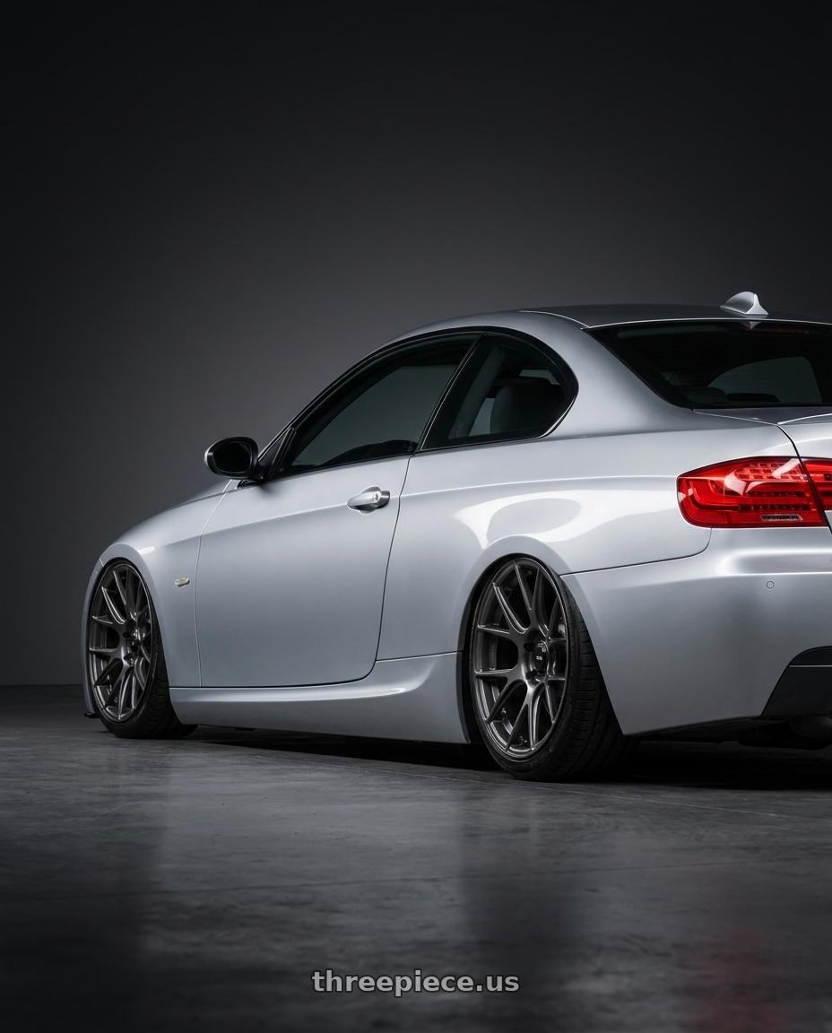 2012 BMW 3 Series E92 with Konig Ampliform 5x120 18x8.5+32 Dark Metallic Graphite wheels rear three quarter view slight stretch tires
