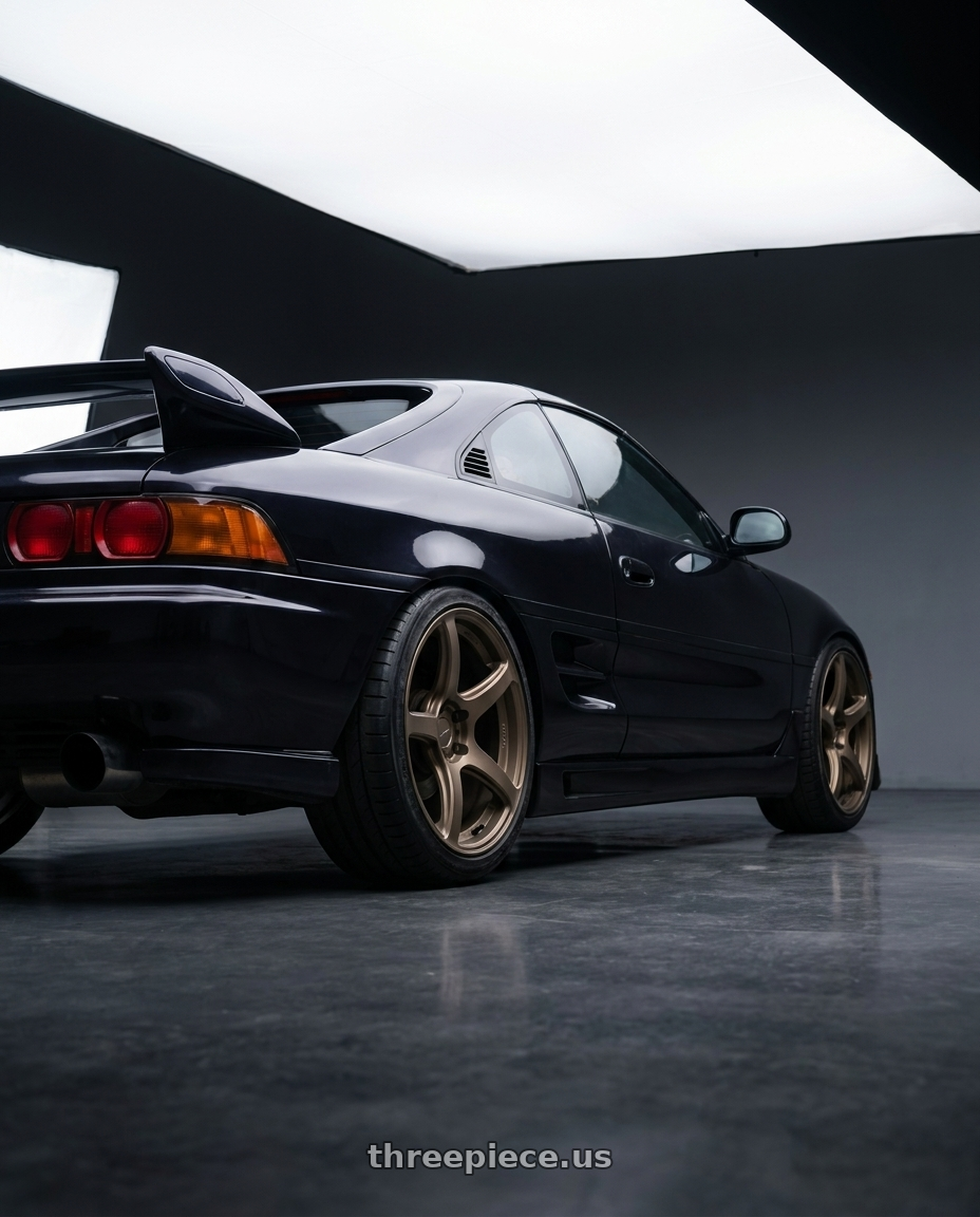 1998 Toyota MR2 with Work Emotion T7r 5x100 18x8.5 +30 Matte Bronze wheels rear three quarter view slight stretch tires