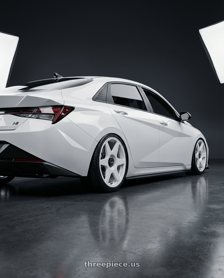 2024 Hyundai Elantra N with fifteen52 TARMAC EVO 5x114.3 / 5x120 19x8.5 +35 RALLY WHITE (GLOSS WHITE) wheels rear three quarter view slight stretch tires