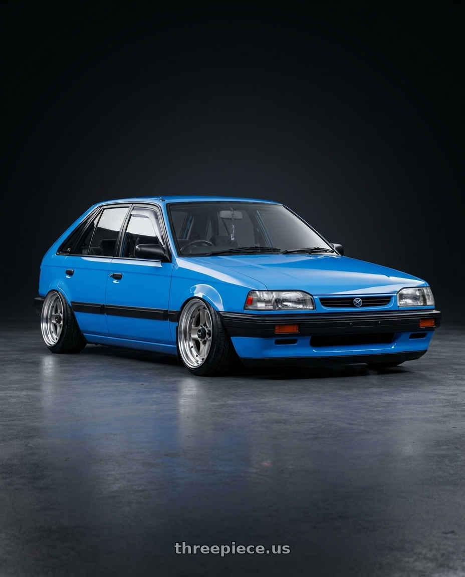 1992 Mazda 323 hatchback B3 in marina blue with Work Equip 40 4x114.3 15x8.5 +29 a disk Brut Silver wheels