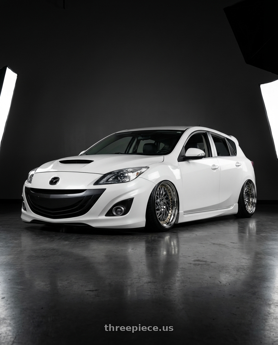 2012 Mazda Mazdaspeed3 with Aodhan DS03 5x114.3 18x9.5 +30 Vacuum Chrome w/Gold Rivets wheels front three quarter view stanced stance