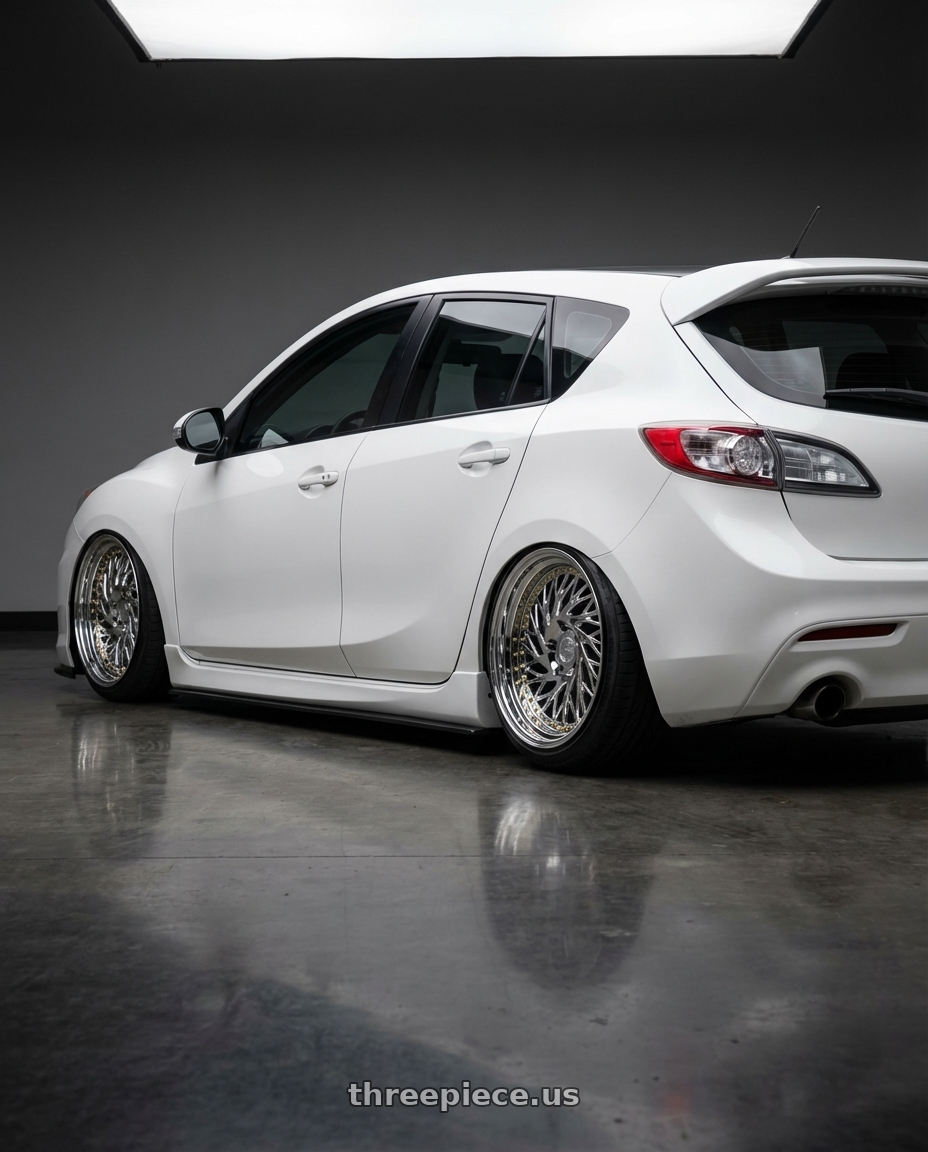 2012 Mazda Mazdaspeed3 with Aodhan DS03 5x114.3 18x9.5 +30 Vacuum Chrome w/Gold Rivets wheels rear three quarter view slight stretch tires