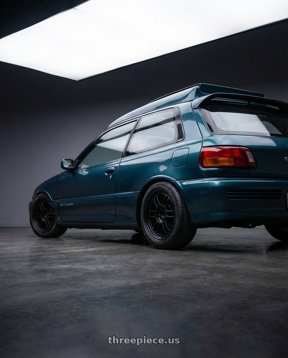 Starlet gt turbo 1994 with Enkei RPF1 4x100 15x7+35 Black wheels rear three quarter view square tires