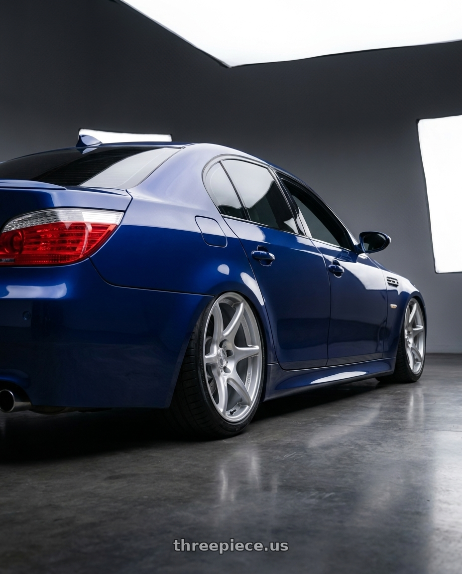 2010 BMW M5 E60 with Kansei K11S Tandem 5X120 19x10.5 22 Hyper Silver wheels rear three quarter view slight stretch tires