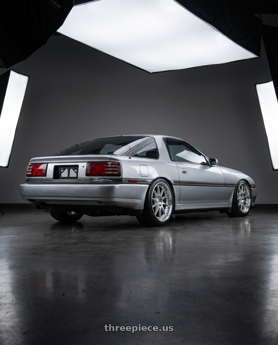 1987 Toyota Supra pre face lift  with Aodhan DS07 5x114.3 18x9.5+30 Silver w/Machined Face wheels rear three quarter view slight stretch tires