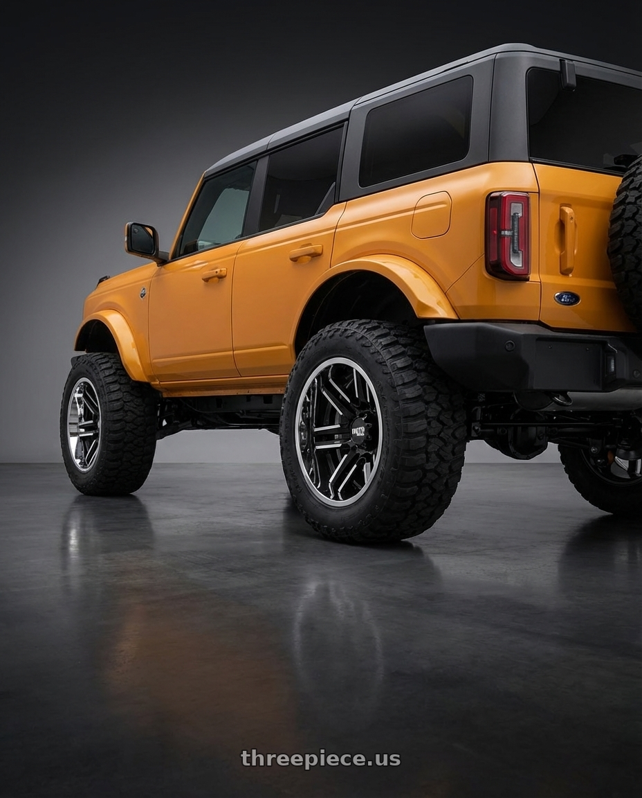 2024 Ford Bronco with Moto Metal MO202 6X139.7 20X10 -18 GLOSS BLACK MACHINED CENTER CHROME LIP wheels rear three quarter view meaty tires