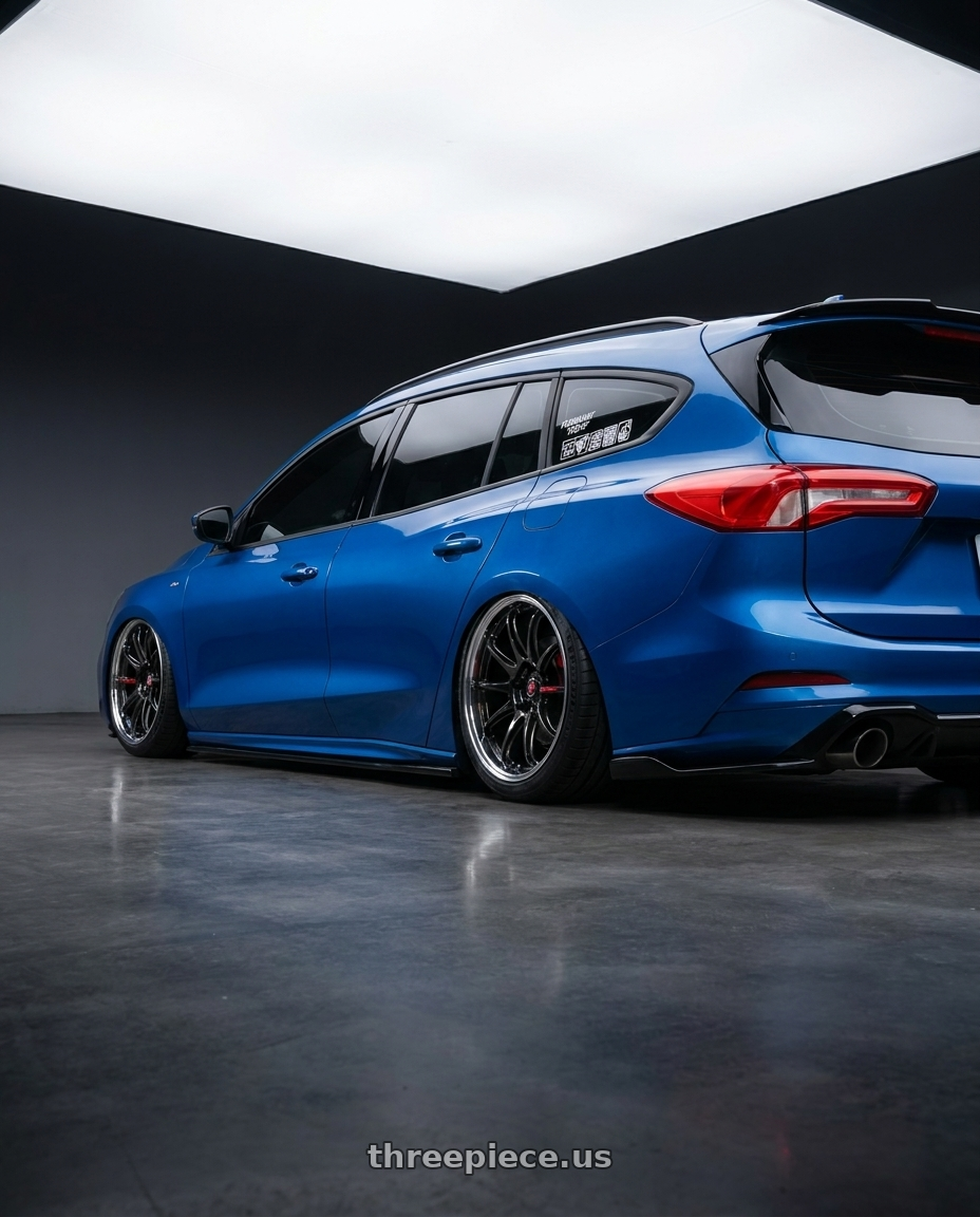 2023 focus wagon with Work Zr10 2P 5x108 18x10.0 +38 Glim Black wheels rear three quarter view square tires