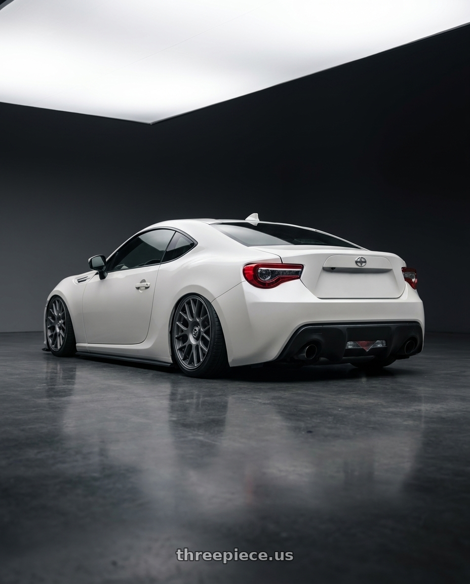 2016 Scion FR-S with fifteen52 APEX 5x100 / 5x114.3 18x8.5 +35 FROSTED GRAPHITE (SATIN GREY) wheels rear three quarter view slight stretch tires