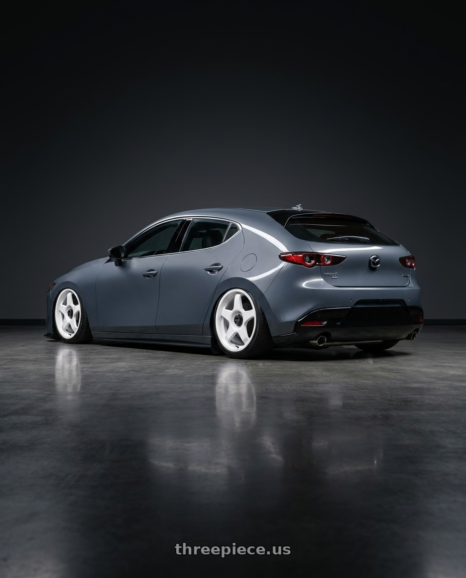 2023 Mazda Mazda3 Turbo with fifteen52 CHICANE 5x114.3 / 5x100 18x8.5 +35 RALLY WHITE (GLOSS WHITE) wheels rear three quarter view slight stretch tires