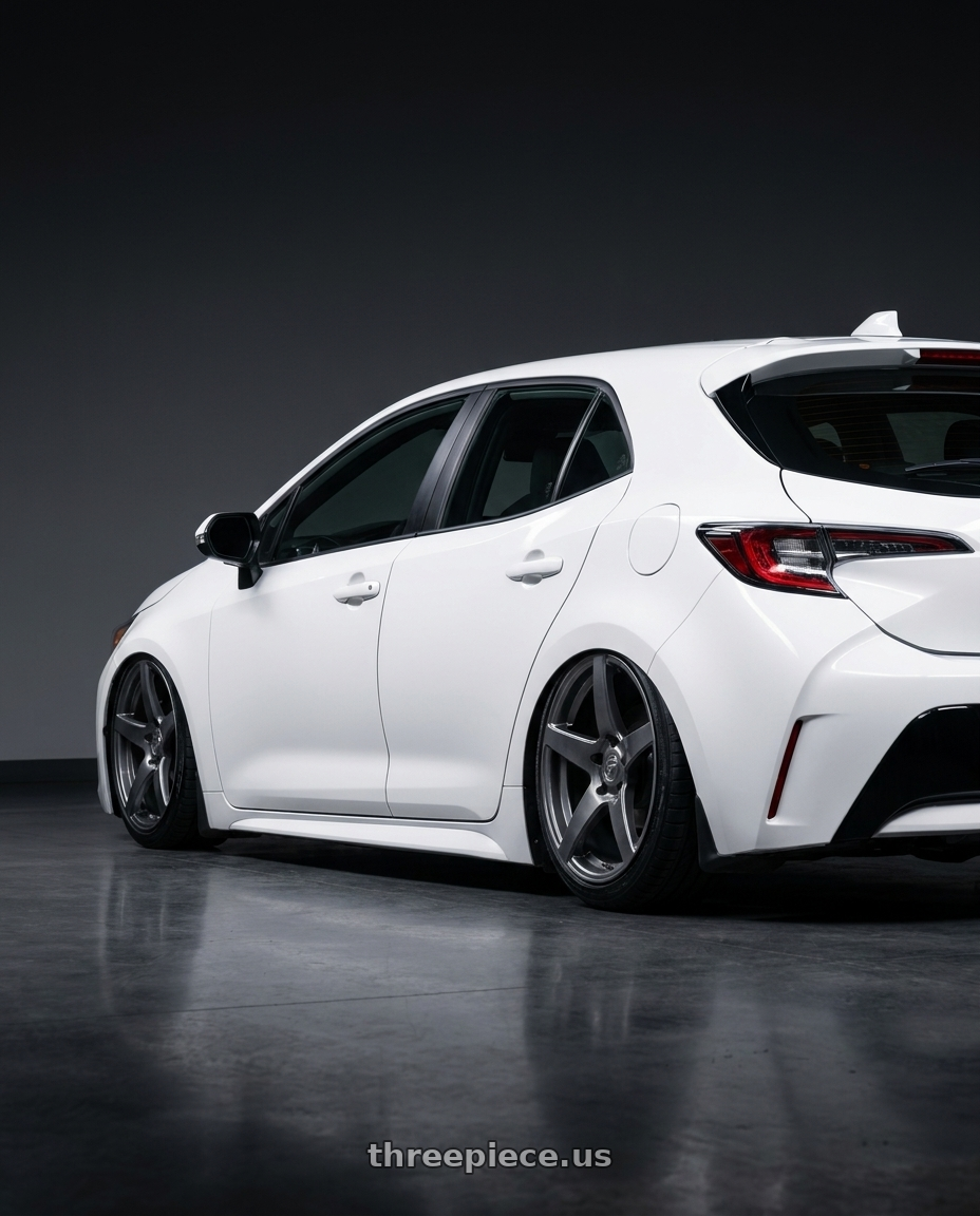 2023 Toyota Corolla Hatchback with Forgestar CF5 5x114.3 18x10 +42 Gloss Anthracite wheels rear three quarter view slight stretch tires