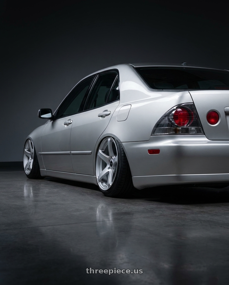 1999 Lexus is200 with Enkei Kojin 5x114.3 17x8+35 Matte Silver wheels rear three quarter view slight stretch tires