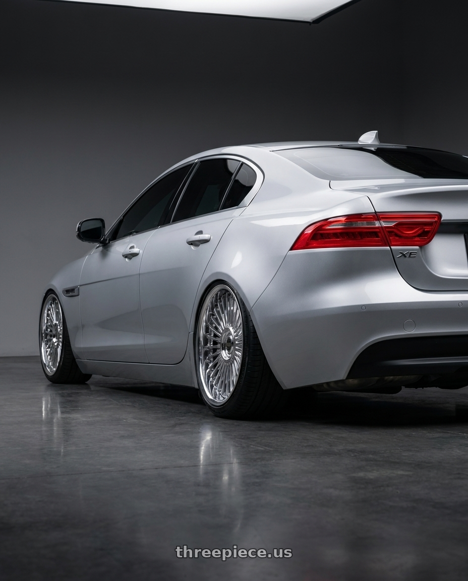 2017 Jaguar XE Premium with Work Emitz wheels rear three quarter view slight stretch tires