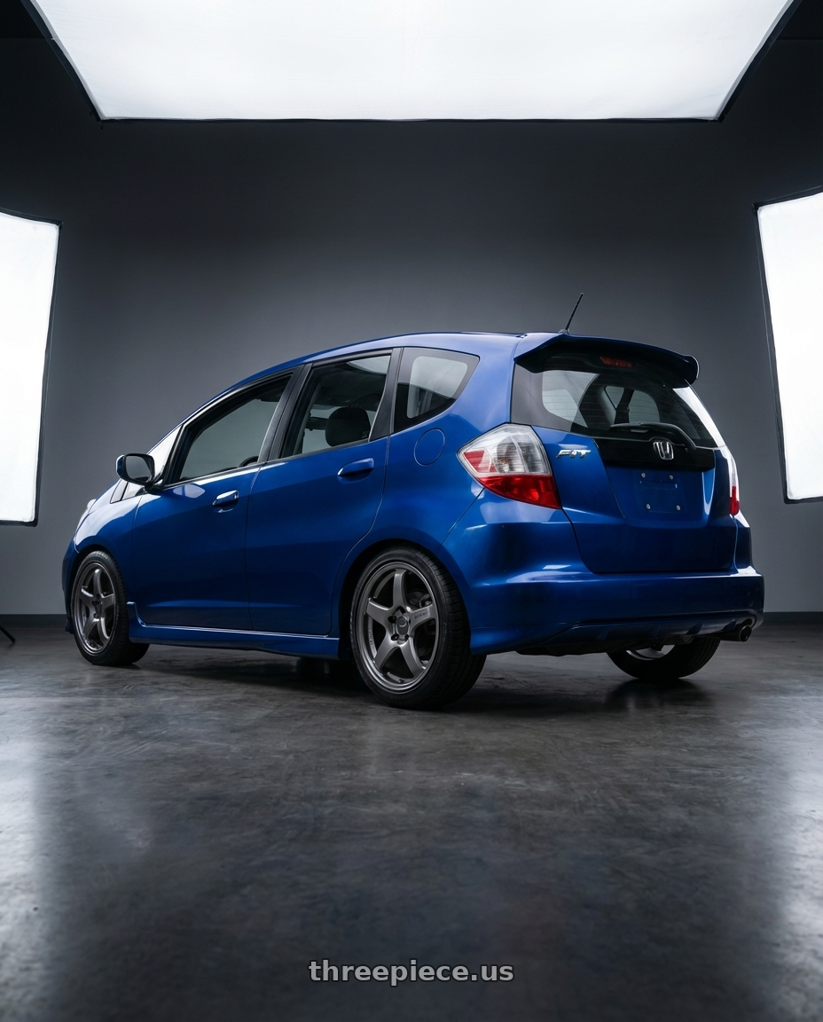 2010 Honda Fit Sport with Enkei PF05 4x100 17x7+45 Dark Silver wheels rear three quarter view square tires