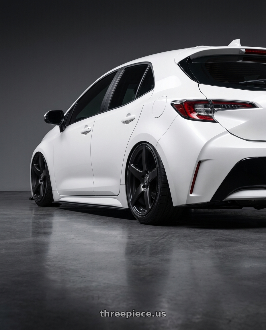 2023 Toyota Corolla Hatchback with Forgestar CF5 5x114.3 18x10 +42 Satin Black wheels rear three quarter view slight stretch tires