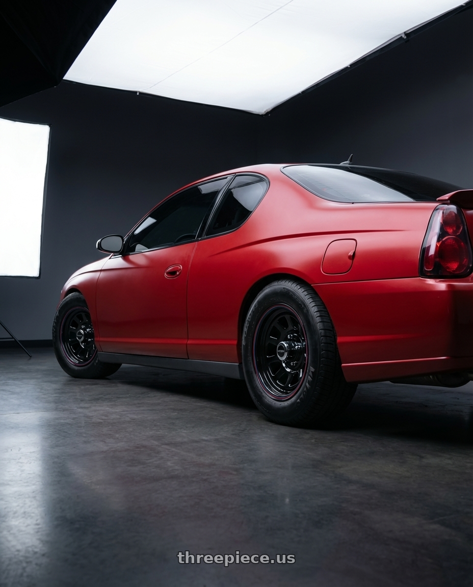 2006 Monte Carlo LT with American Racing AR767 5X114.3 15X8 -12 GLOSS BLACK W/ STRIPES wheels rear three quarter view meaty tires