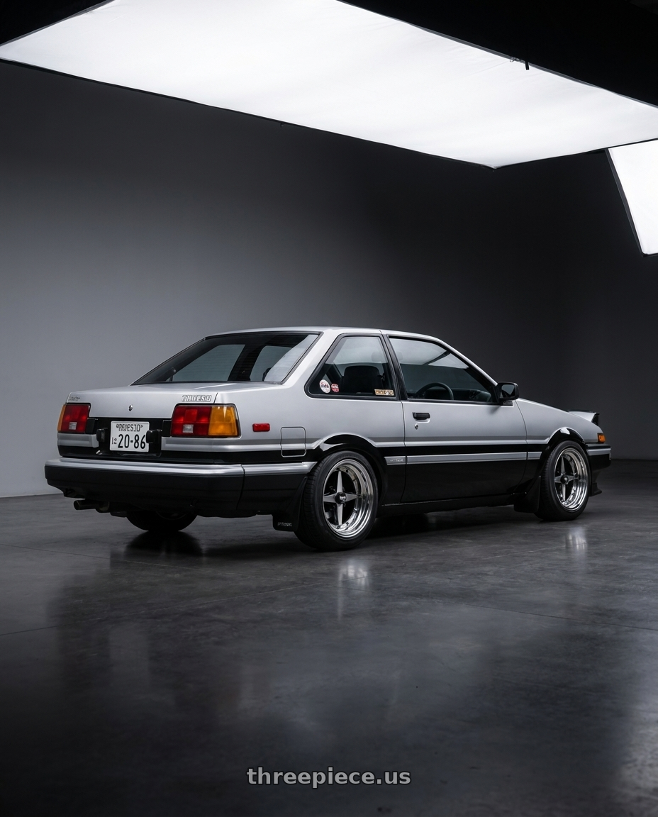 1986 Toyota Corolla Sport DLX with Equip 01 Black Polish 4x100 15x8.5 +29 wheels rear three quarter view square tires