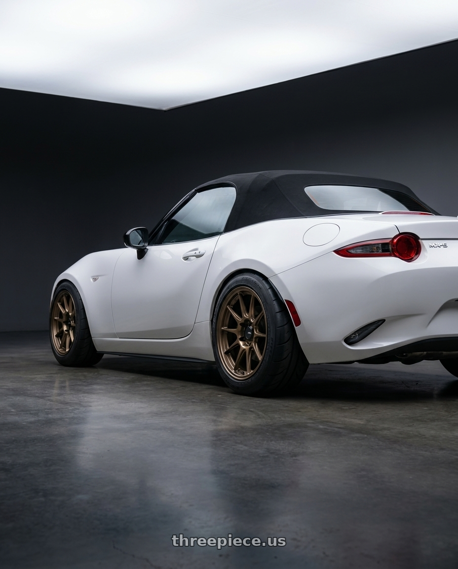 2024 nd mx5 soft top with Konig Dekagram 4x100 15x7.5+35 Gloss Bronze wheels rear three quarter view meaty tires