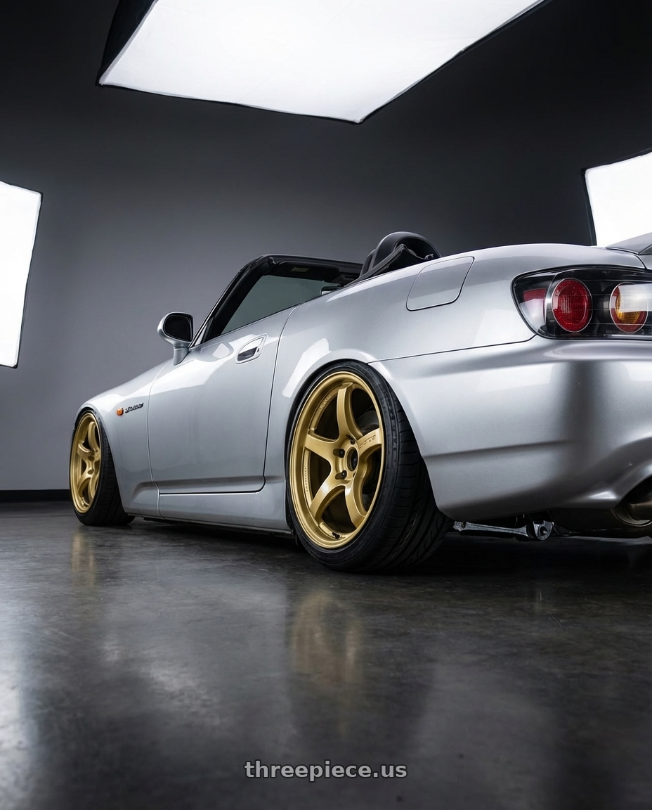 2009 Honda S2000 with Gram Lights 57CR 5x114.3 18x9.5 +38 Almite Gold wheels rear three quarter view slight stretch tires