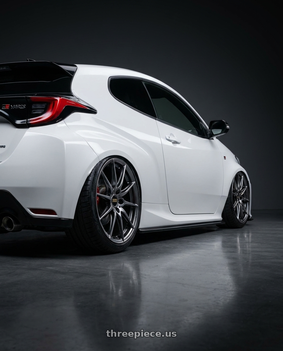 2025 Gr yaris with BBS RE-V7 5x112 18x8.5 +42 Diamond Black wheels rear three quarter view slight stretch tires