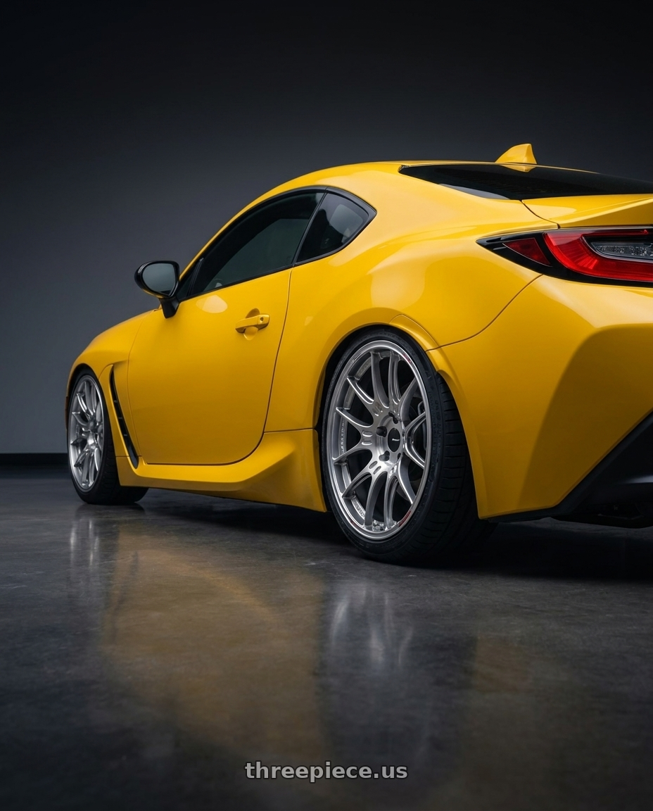2026 Subaru BRZ Series.Yellow with Enkei GTC02 5x100 18x8+45 Hyper Silver wheels rear three quarter view square tires
