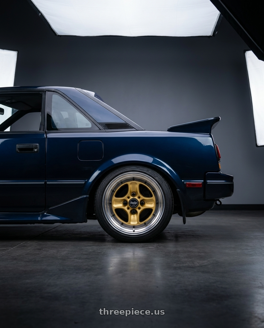 1987 Toyota MR2 with Work Equip 40 4x100 15x7 +32 o disk Sprint Gold wheels rear three quarter view square tires