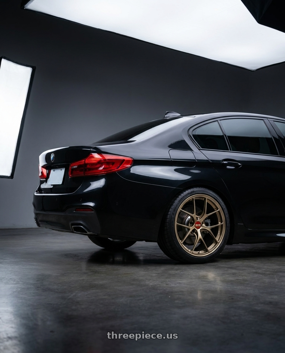 2019 bmw 5 series  with BBS RI-D 5x112 21x10.5 +10 Diamond Gold wheels rear three quarter view square tires