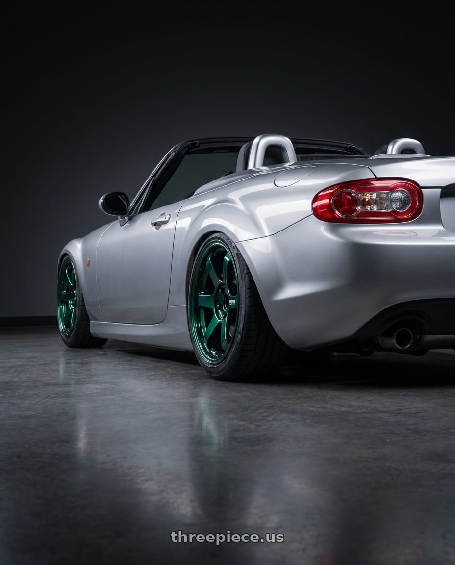 2007 Mazda Miata with Volk Racing TE37 SONIC 4x100 16x8+35 Racing Green wheels rear three quarter view extreme stretch tires