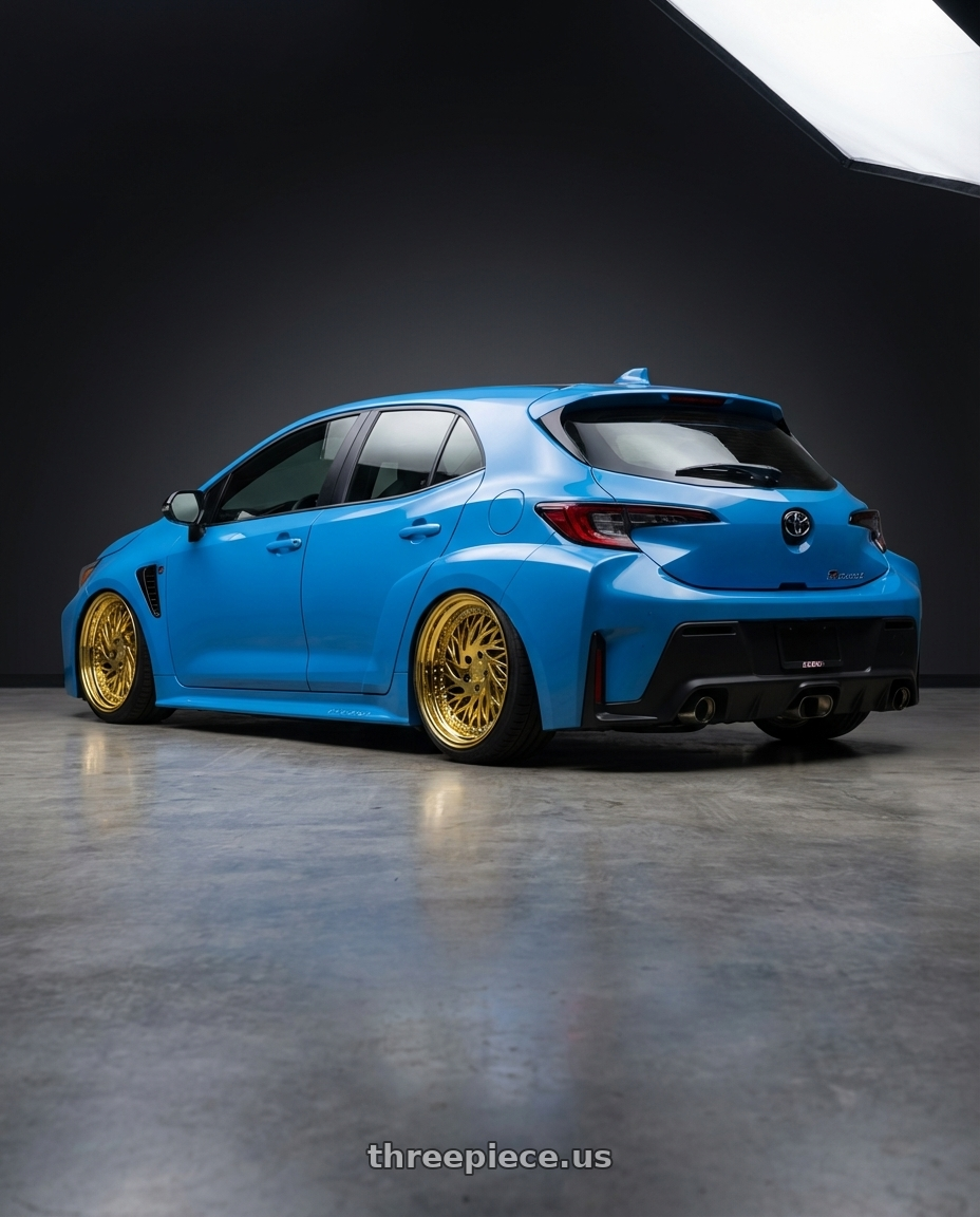 2024 Toyota GR Corolla with Aodhan DS03 5x114.3 18x9.5 +30 Gold Vacuum w/ Chrome Rivets wheels rear three quarter view slight stretch tires