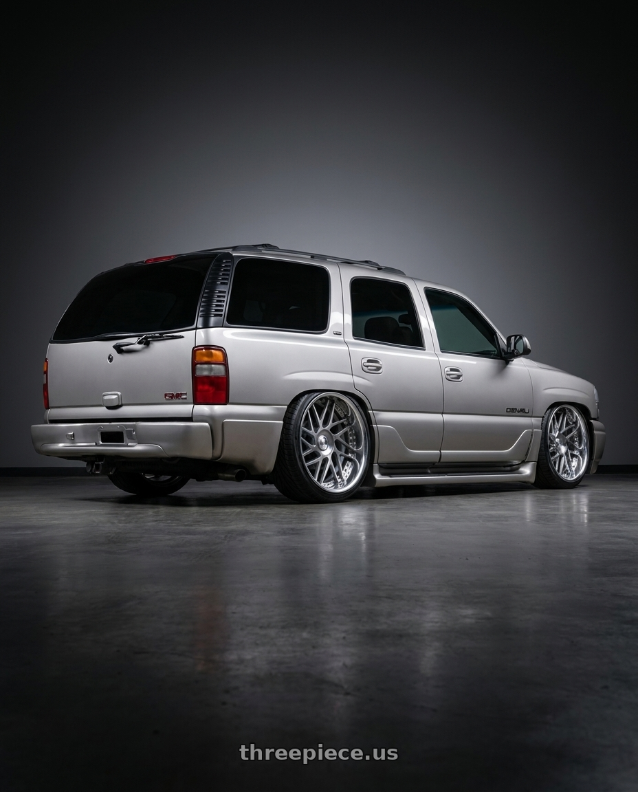 2005 GMC Yukon with Leon Hardiritt Geist 21x12.0+30 Super Low Disk wheels rear three quarter view extreme stretch tires
