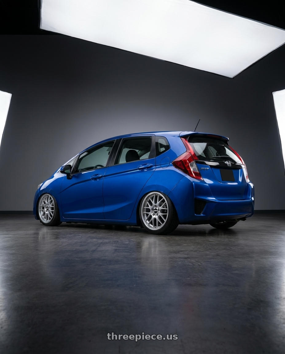 2015 Honda fit bule with BBS RG-R 4x100 17x7.0+38 Diamond Silver wheels rear three quarter view slight stretch tires