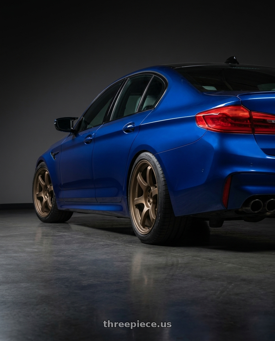 2018 BMW M5 with Gram Lights 57DR 5x112 19x9.5 +25 BRONZE 2 wheels rear three quarter view square tires