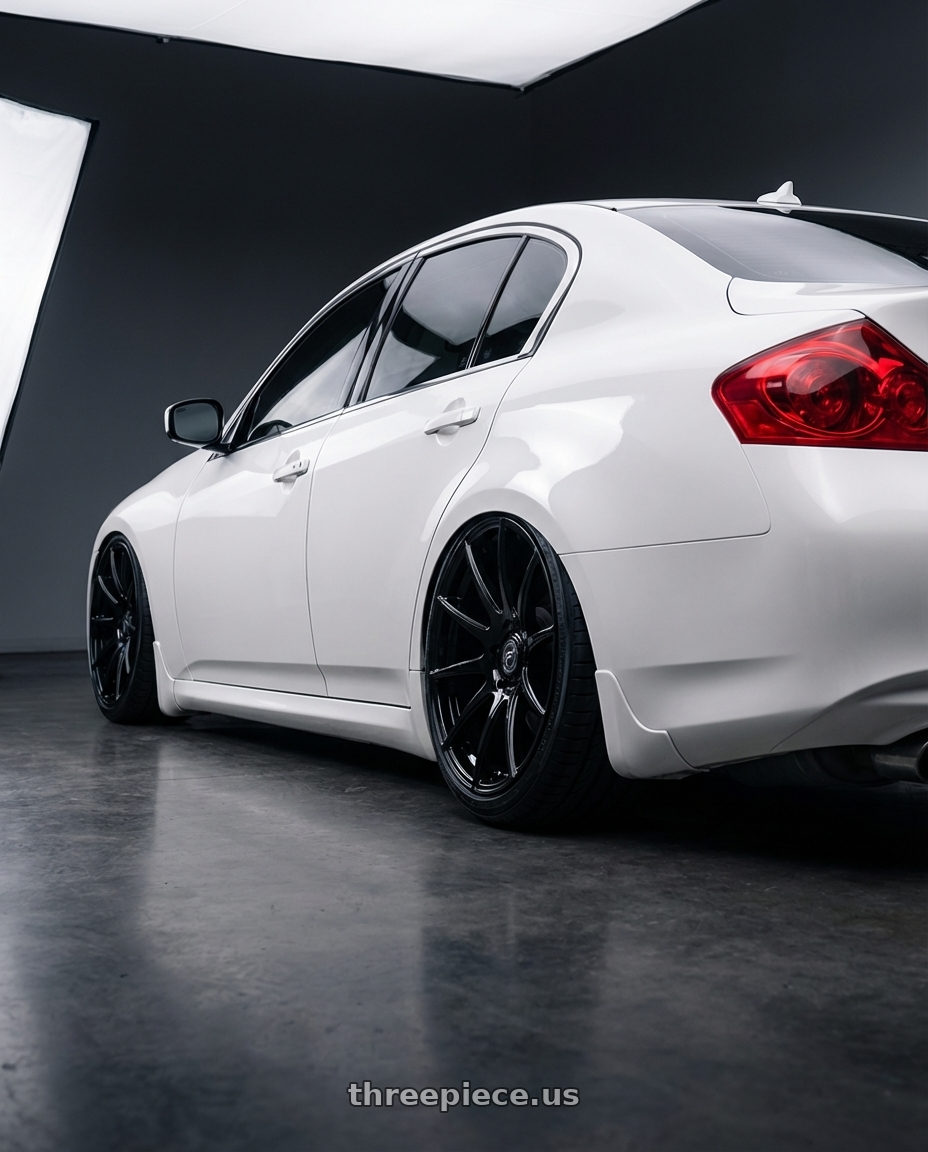 2012 Infiniti G37 with Forgestar CF10 5x114.3 19x10 +42 Gloss Black wheels rear three quarter view slight stretch tires