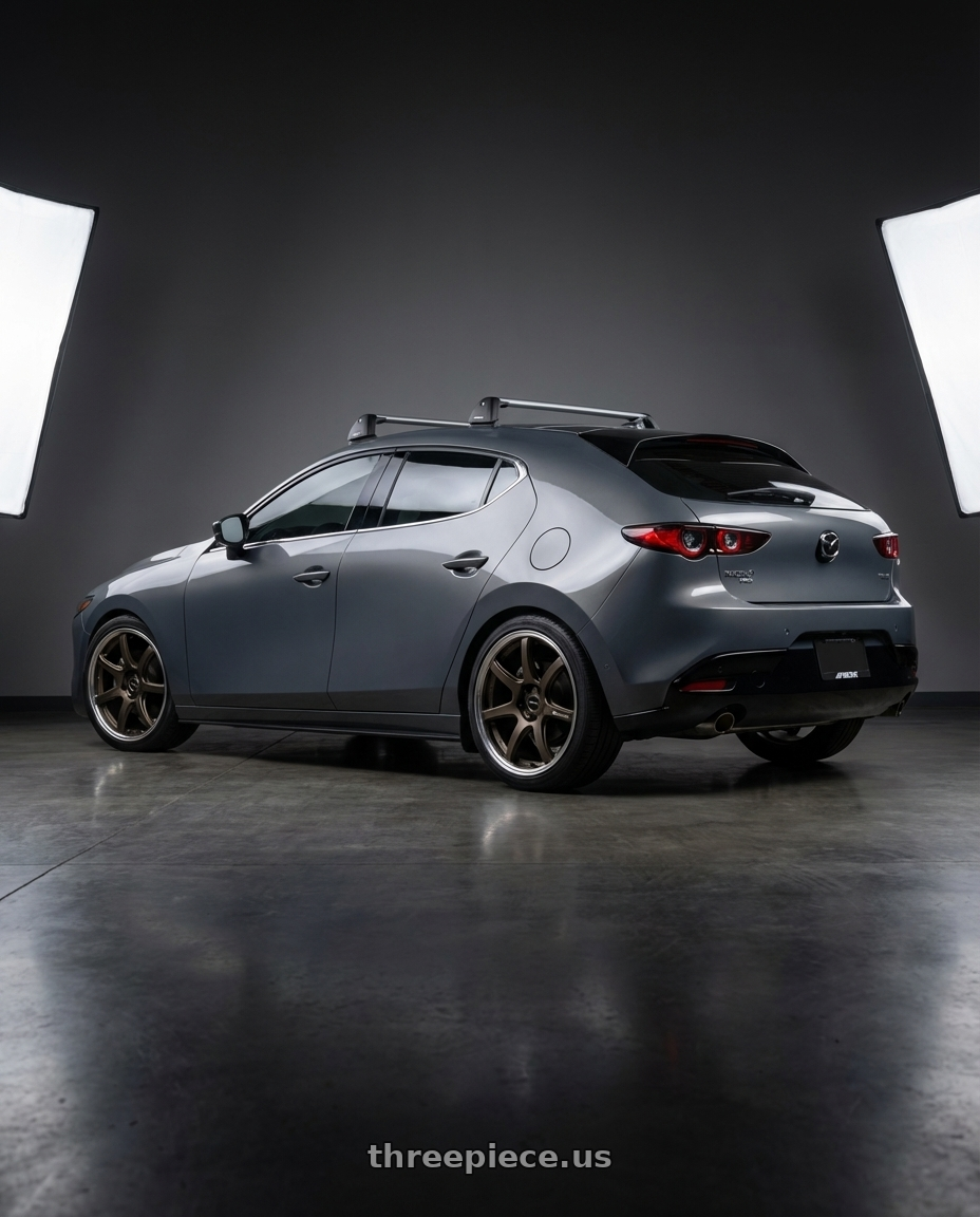 2025 mazda 3 hatch turbo premium plus, grey with Work Emotion T7R 2P wheels rear three quarter view square tires