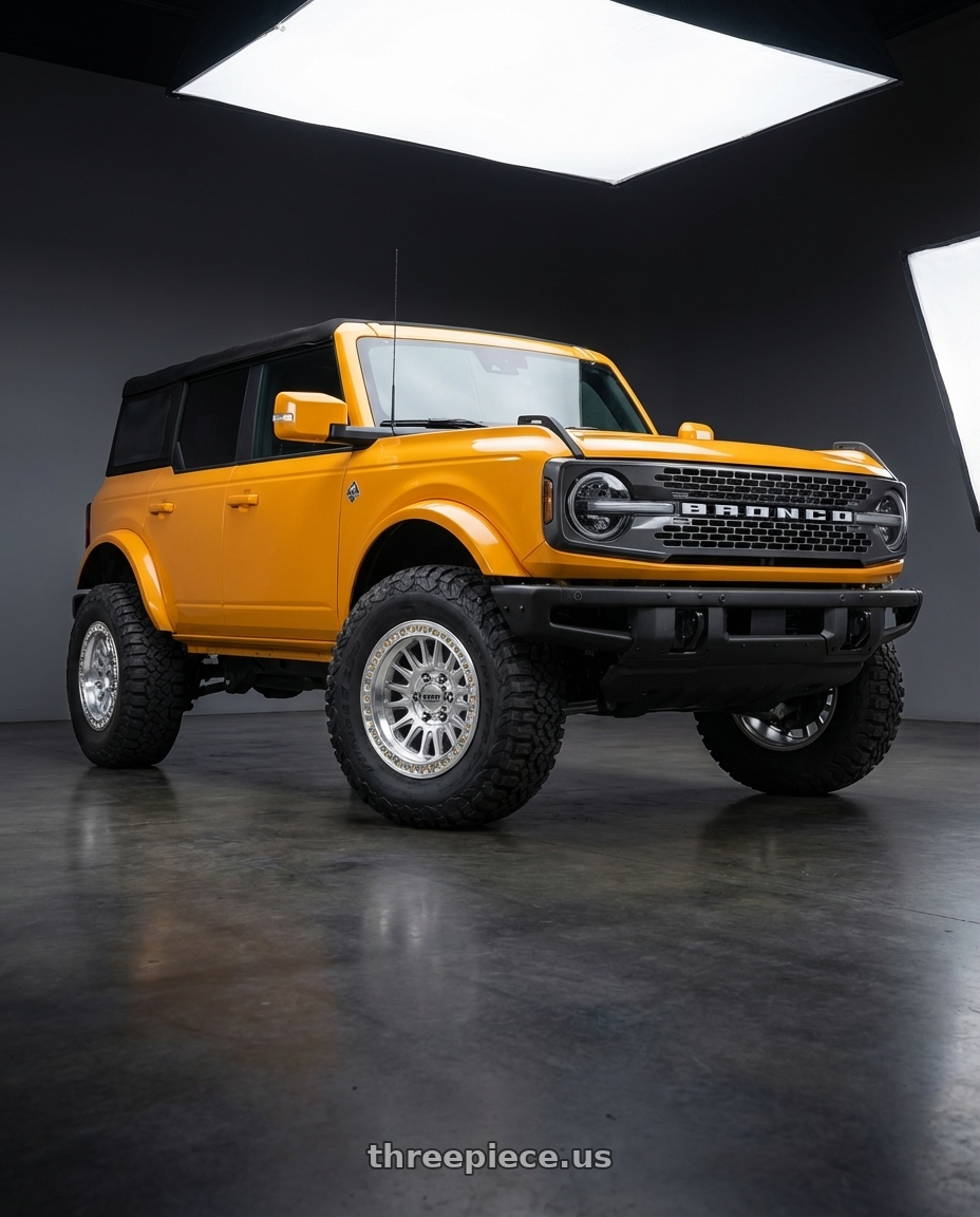 2024 Ford Bronco with KMC KM552 IMS 6X139.7 20x9 +18 GLOSS SILVER W/ MACHINED FACE wheels front three quarter view lifted stance